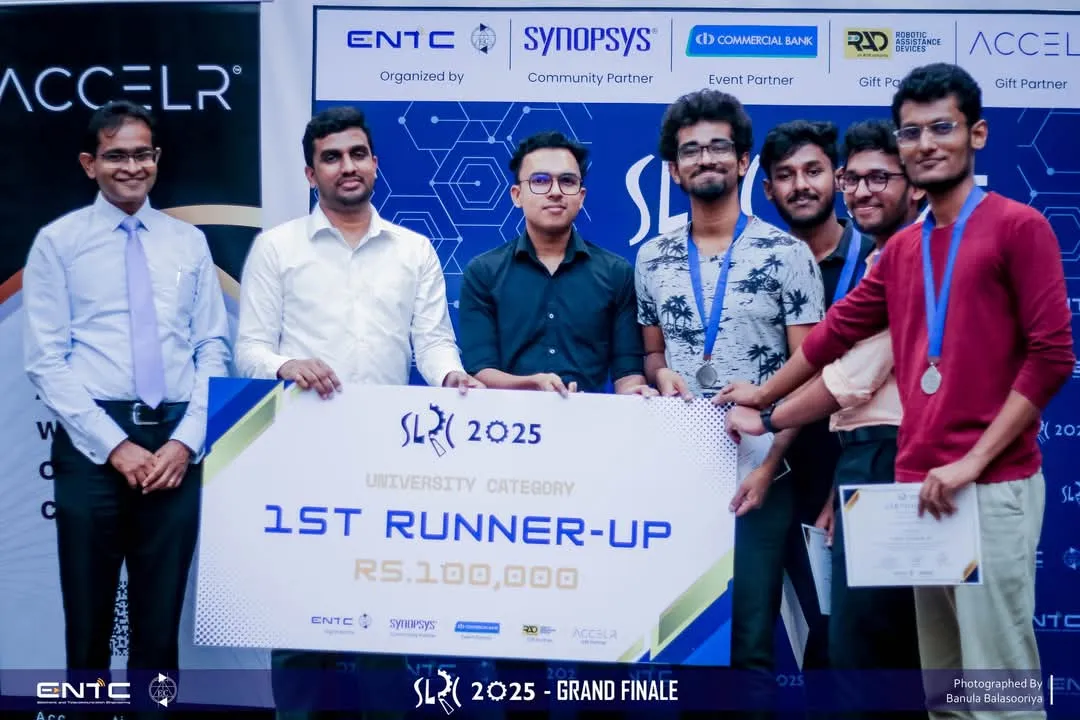 The team on stage holding an oversized cheque reading SLRC 2025, University Category, 1st Runner-Up.
